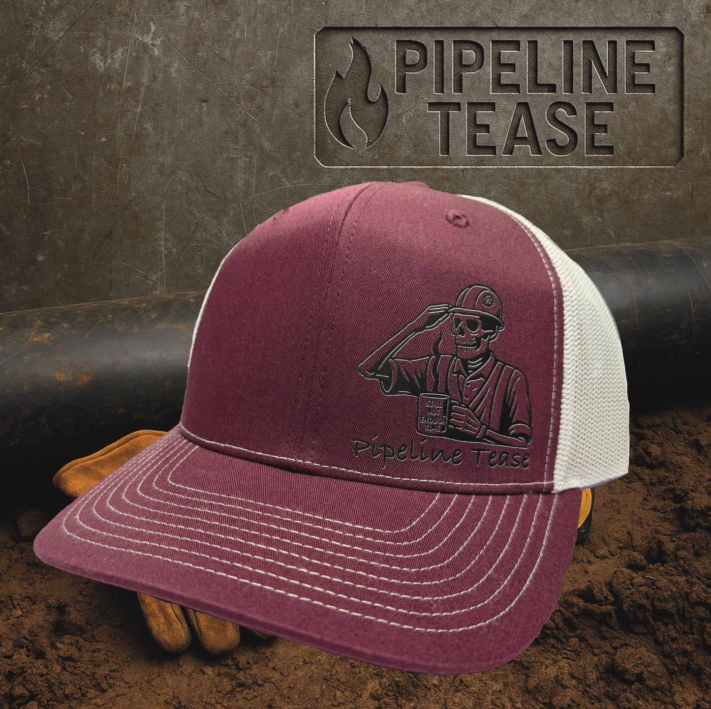 Maroon and white trucker hat featuring the Pipeline Tease black Still Not Enough Time logo holding a coffee cup, displayed on a dirt jobsite background with Pipeline Tease branding.