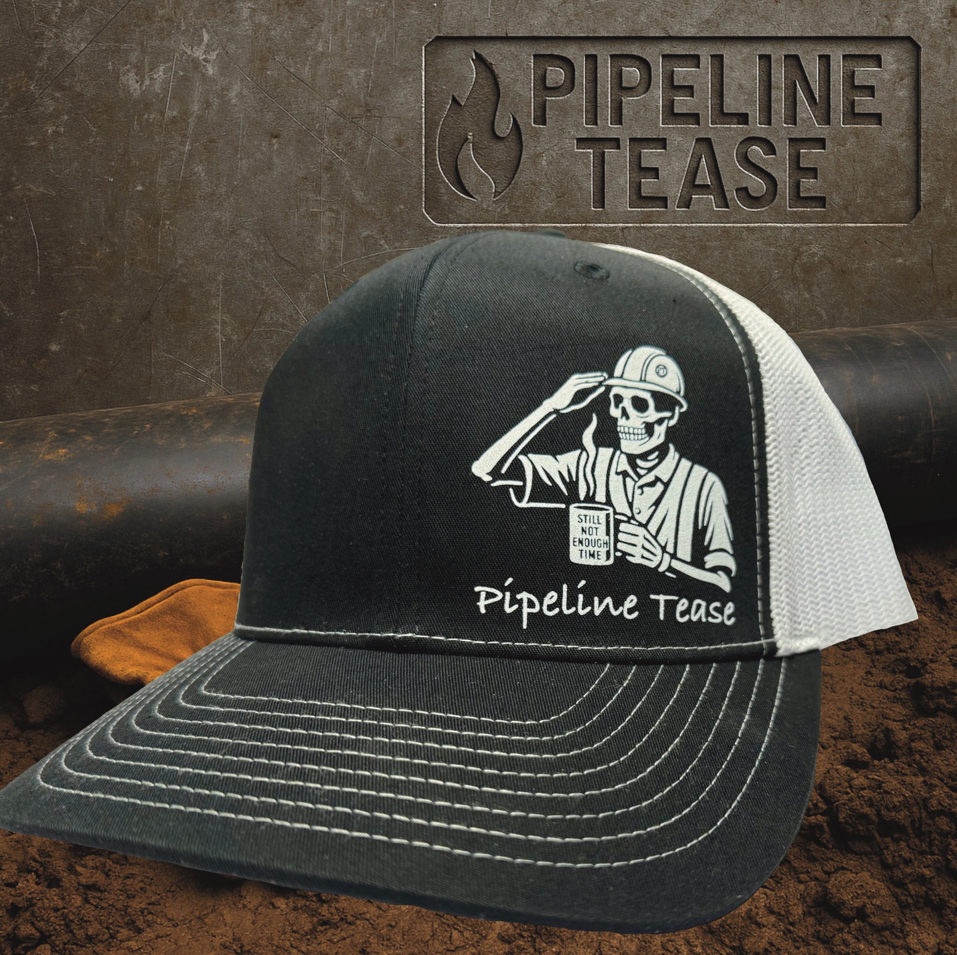Black and white trucker hat featuring the Pipeline Tease white Still Not Enough Time logo holding a coffee cup, displayed on a dirt jobsite background with Pipeline Tease branding.